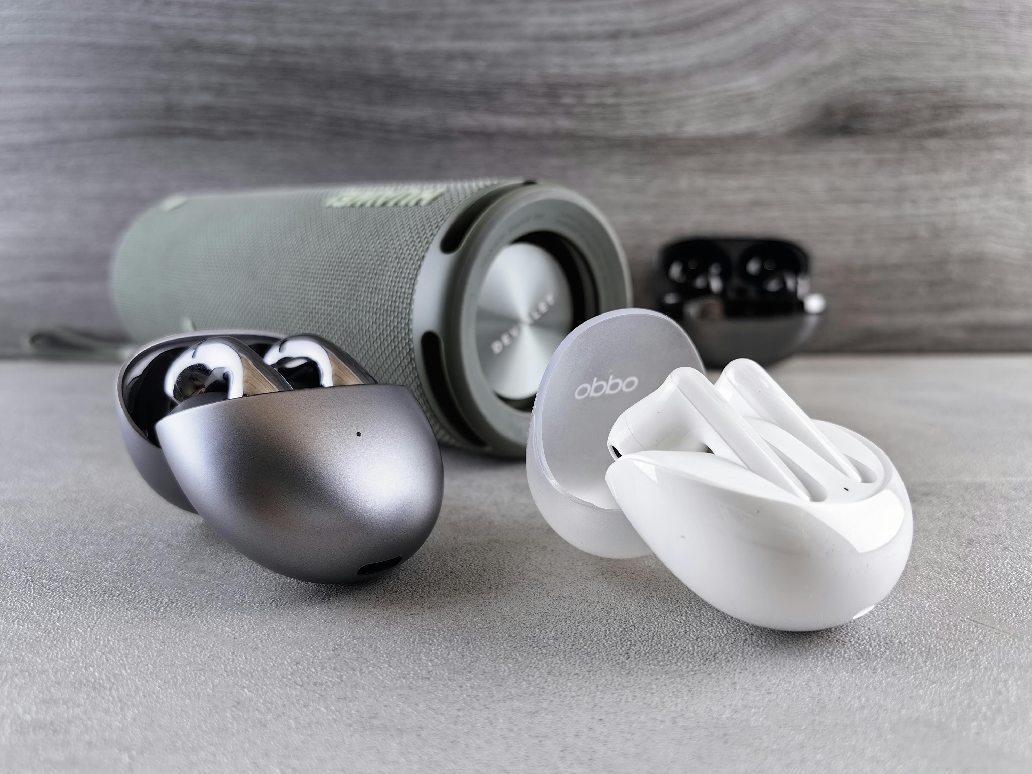 Wireless earbuds displayed with a portable speaker
